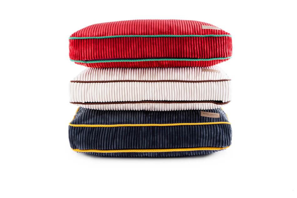 Three Bowl&Bone Republic dog cushion bed DECO sapphire pillows stacked on top of each other.