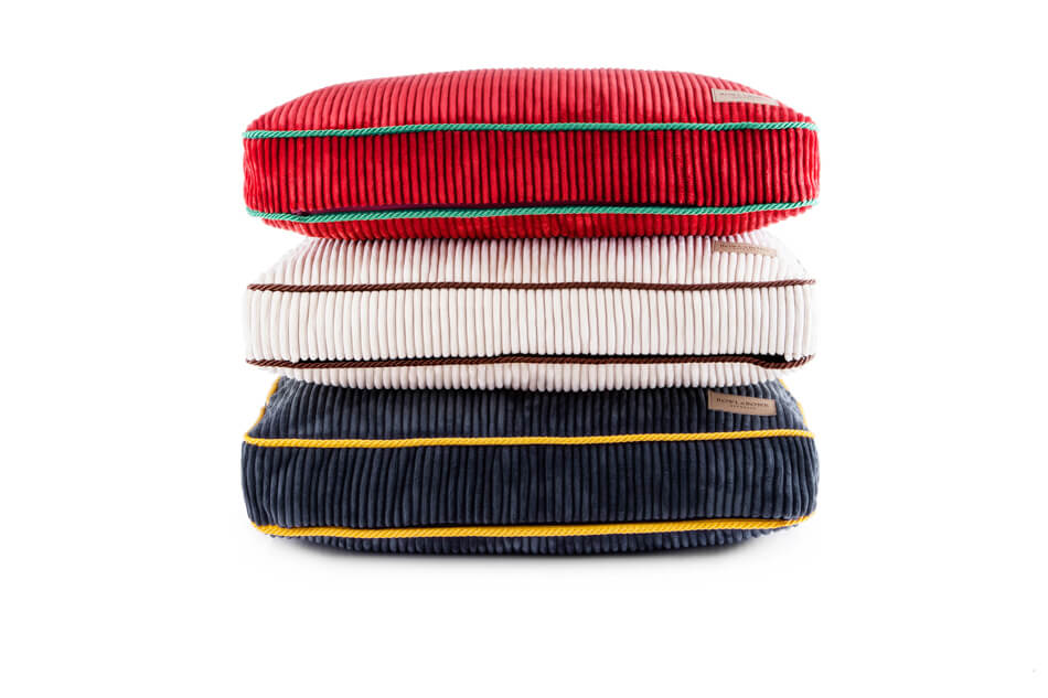 Three Bowl&Bone Republic silver pillows stacked on top of each other.