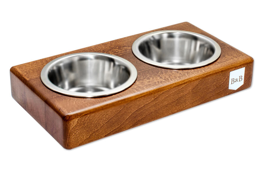 A Bowlandbone dog bowl DUO amber with two stainless steel bowls.