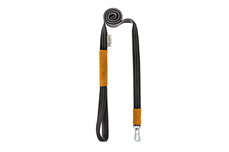 A Bowlandbone Republic dog leash in CANDY yellow with an orange and black handle.