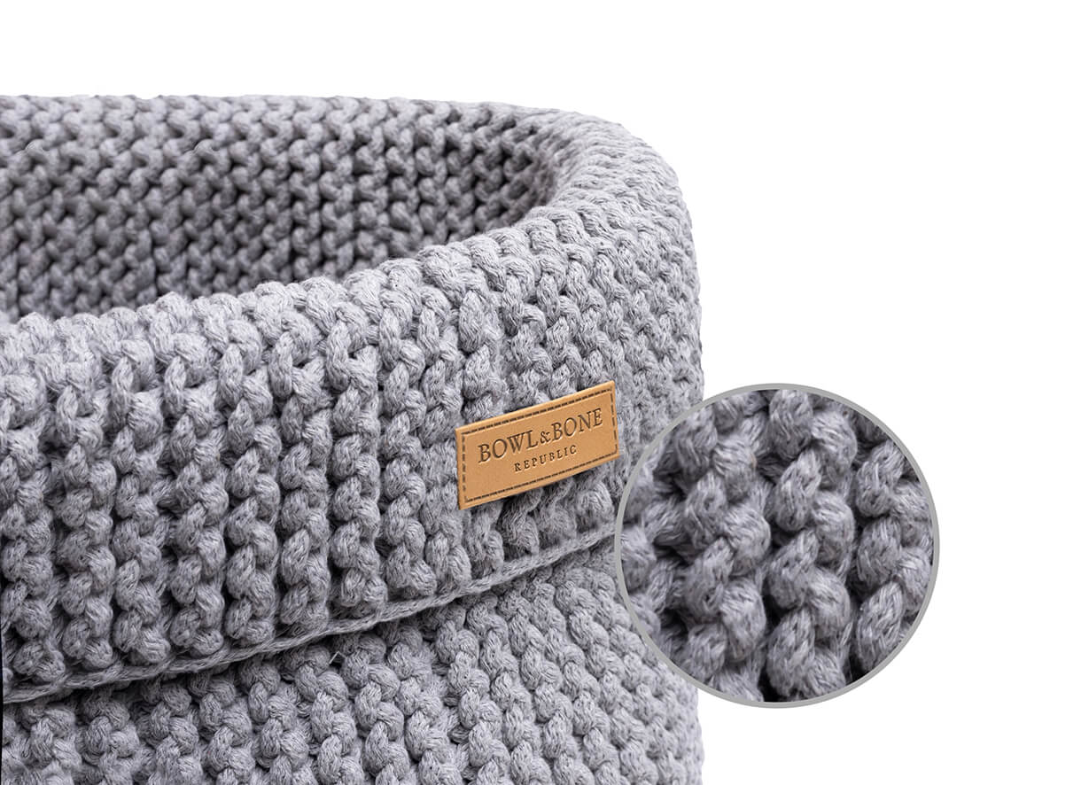 A grey knitted basket for dog toys COTTON with a wooden label by Bowlandbone.