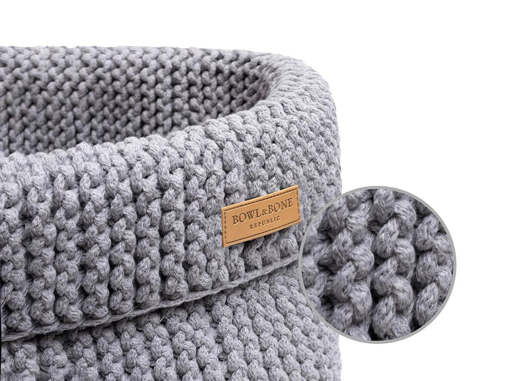A grey knitted basket for dog toys COTTON with a wooden label by Bowlandbone.