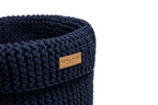 A blue knitted Bowlandbone basket for dog toys COTTON navy with a leather label.