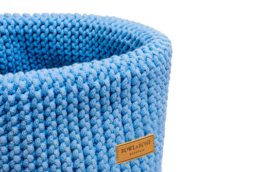A Bowlandbone DOUBLE blue knitted basket for dog toys on a white background.