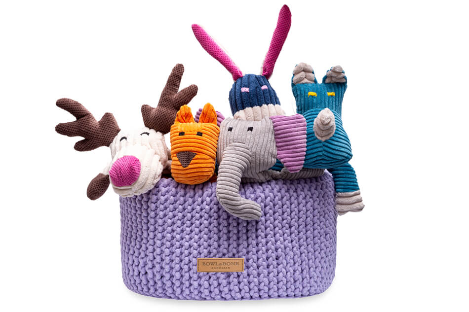 A group of stuffed animals in a Bowlandbone DOUBLE lily basket for dog toys.