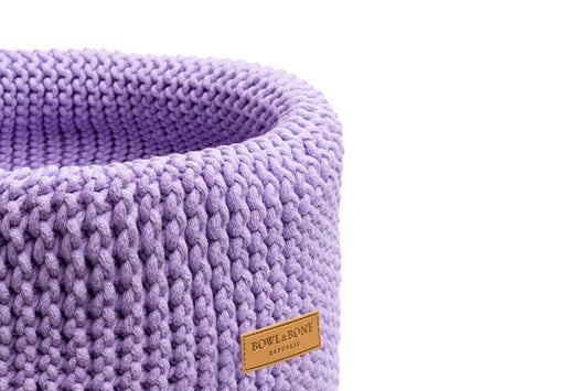 A purple Bowlandbone knitted DOUBLE lily basket for dog toys on a white background.