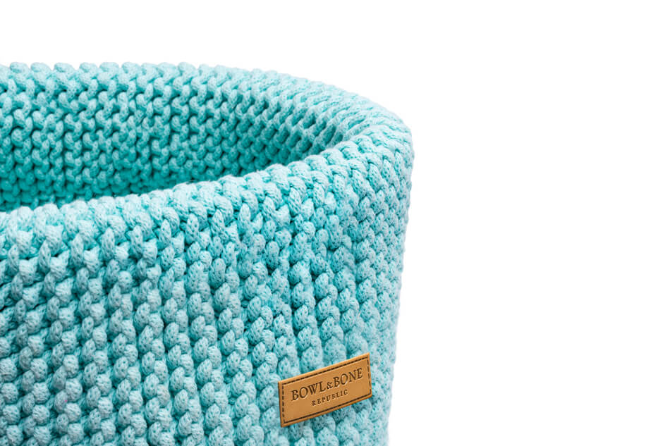 A blue knitted basket for dog toys DOUBLE mint on a white background by Bowlandbone.