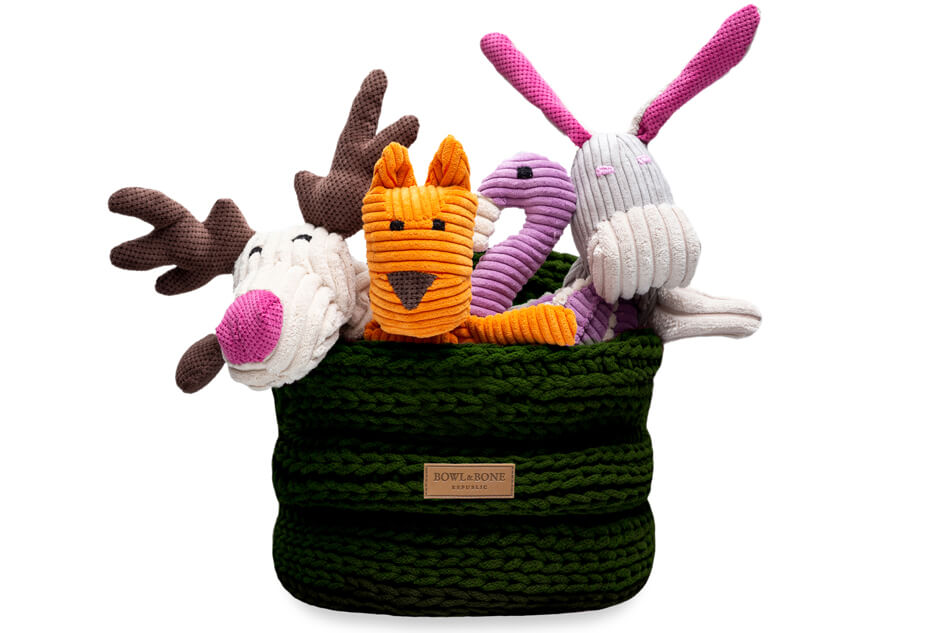 Four stuffed animals in a Bowlandbone basket for dog toys RING green.