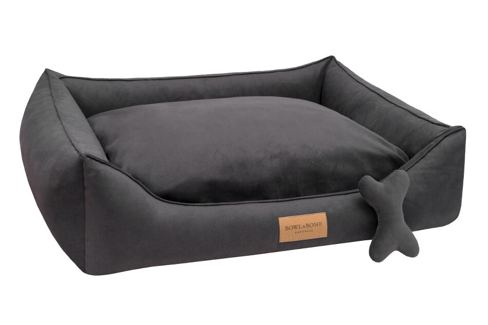 A Bowlandbone Republic dog bed CLASSIC graphite with a bone on it.