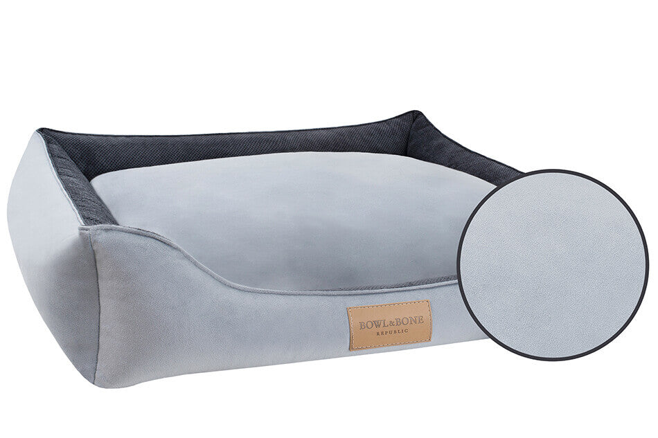 A Bowlandbone dog bed with a black cover, designed by Bowl&Bone Republic.