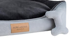 A Bowlandbone dog bed in the CLASSIC grey color featuring a bone motif, designed by Bowl&Bone Republic.