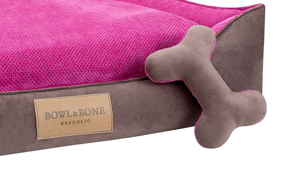 A CLASSIC pink dog bed with a bone on it from Bowlandbone Republic.