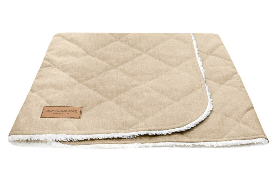 A dreamy Bowl&Bone Republic dog sleeping bag in cream on a white background.