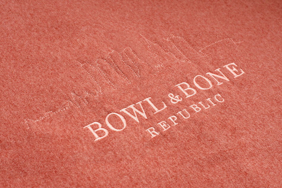 Bowlandbone logo on a red sweatshirt from Bowl&Bone Republic.