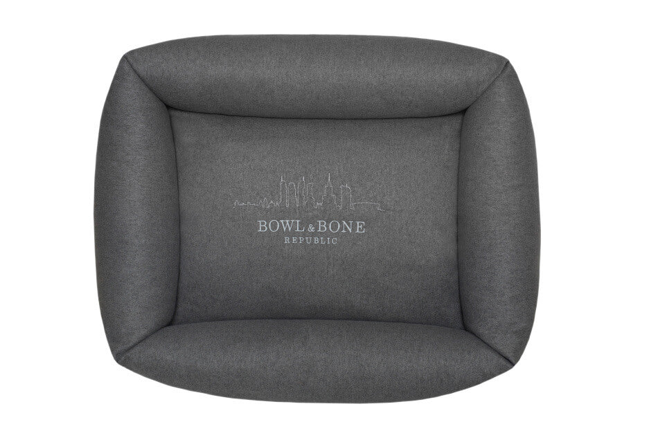 A dog bed with the Bowl&Bone Republic logo on it.