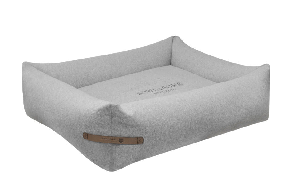 A grey LOFT dog bed featuring a leather strap from Bowl&Bone Republic.