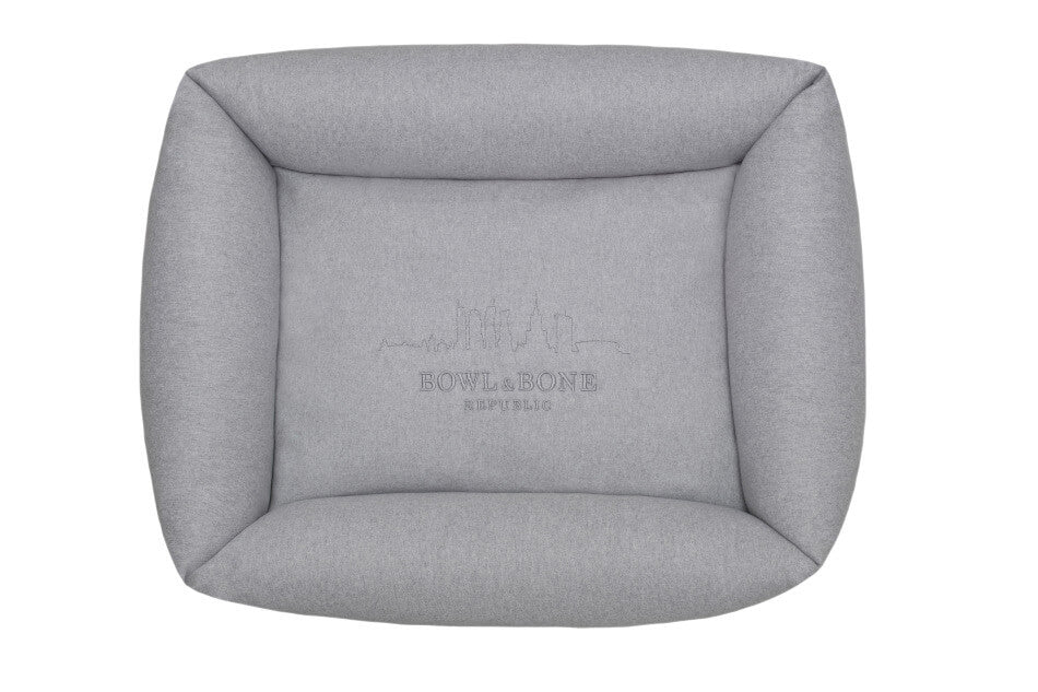 A dog bed LOFT grey with a logo on it by Bowl&Bone Republic.
