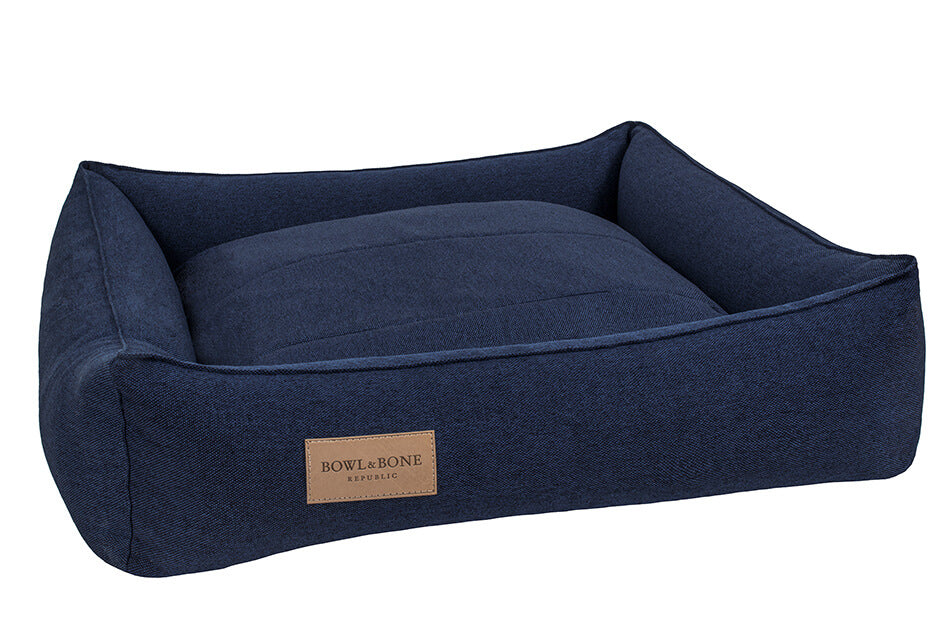 A dog bed URBAN navy with a brown leather tag by Bowl&Bone Republic.