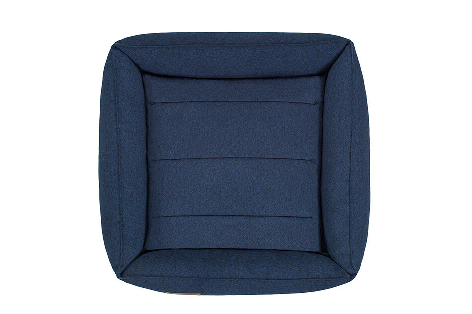 A dog bed URBAN with a blue cover, by Bowlandbone.