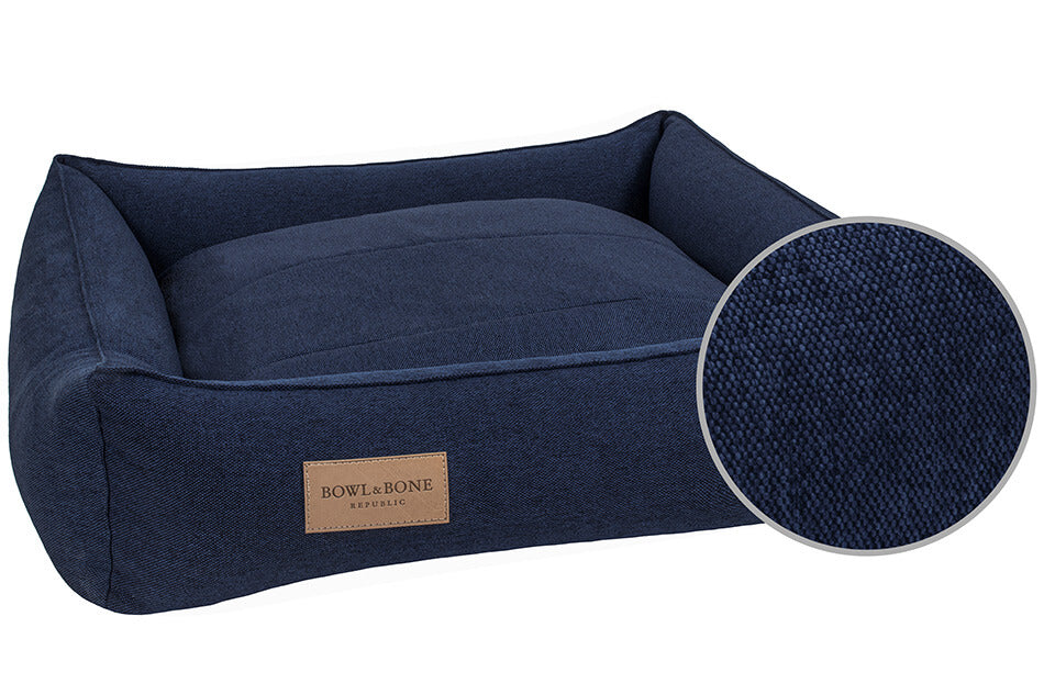A Bowl&Bone Republic dog bed in URBAN navy with a brown label.