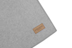 A Zen grey dog blanket made by Bowl&Bone Republic with a brown label on it.