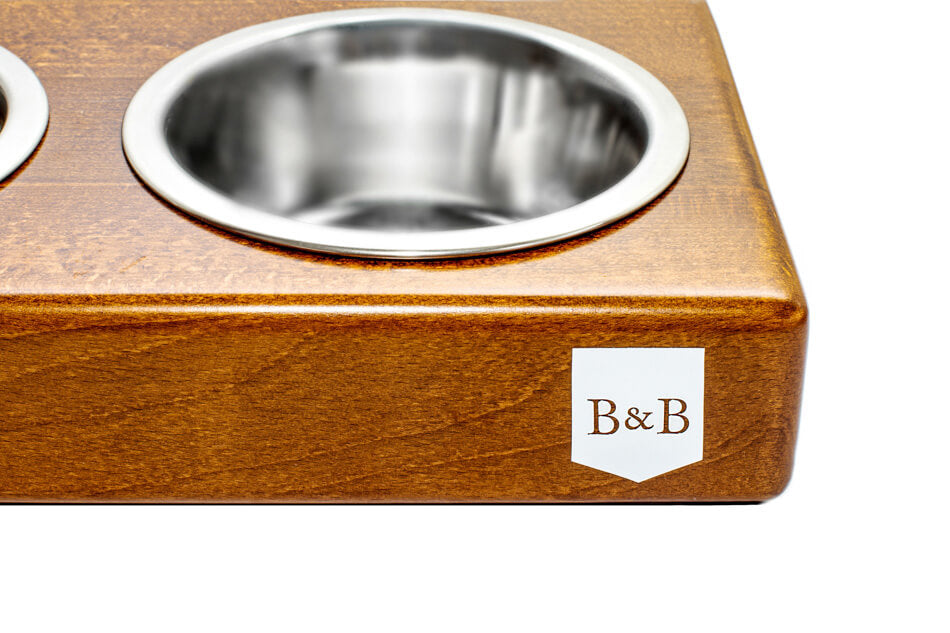 Two Bowl&Bone Republic dog bowls DUO amber on a wooden tray.