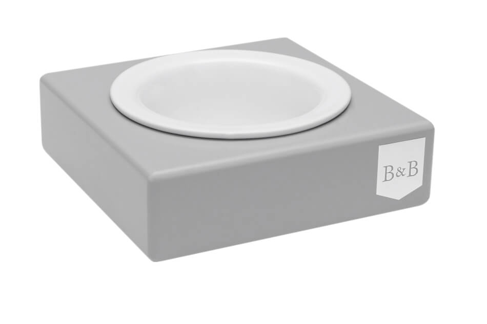 A Bowlandbone dog bowl with a white bowl on top in grey ceramic.