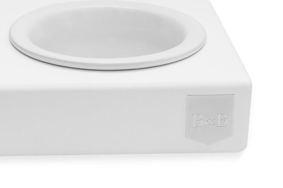 A white dog bowl by Bowlandbone featuring a lid.