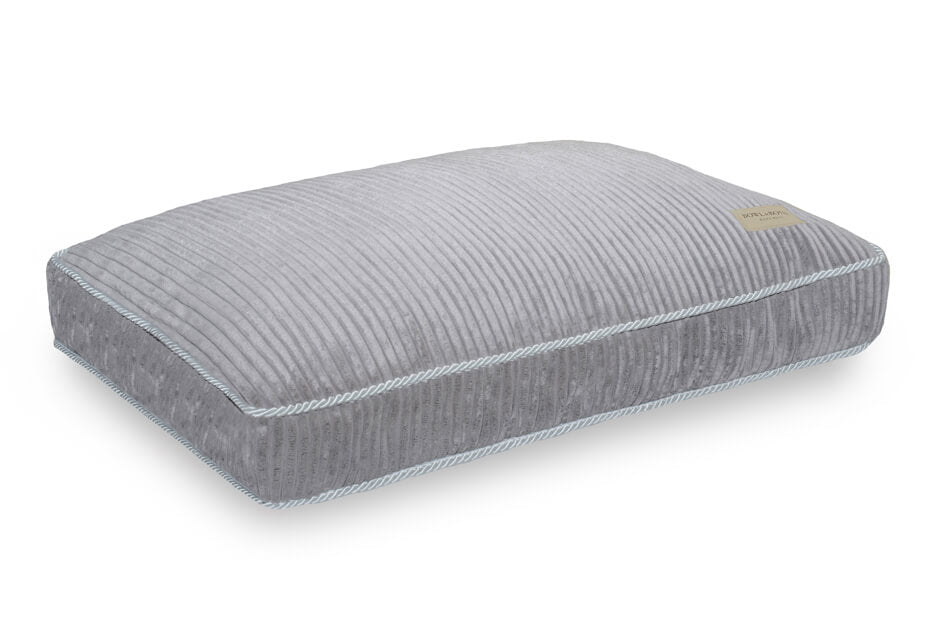 A Bowl&Bone Republic dog cushion bed in DECO silver with a blue trim.
