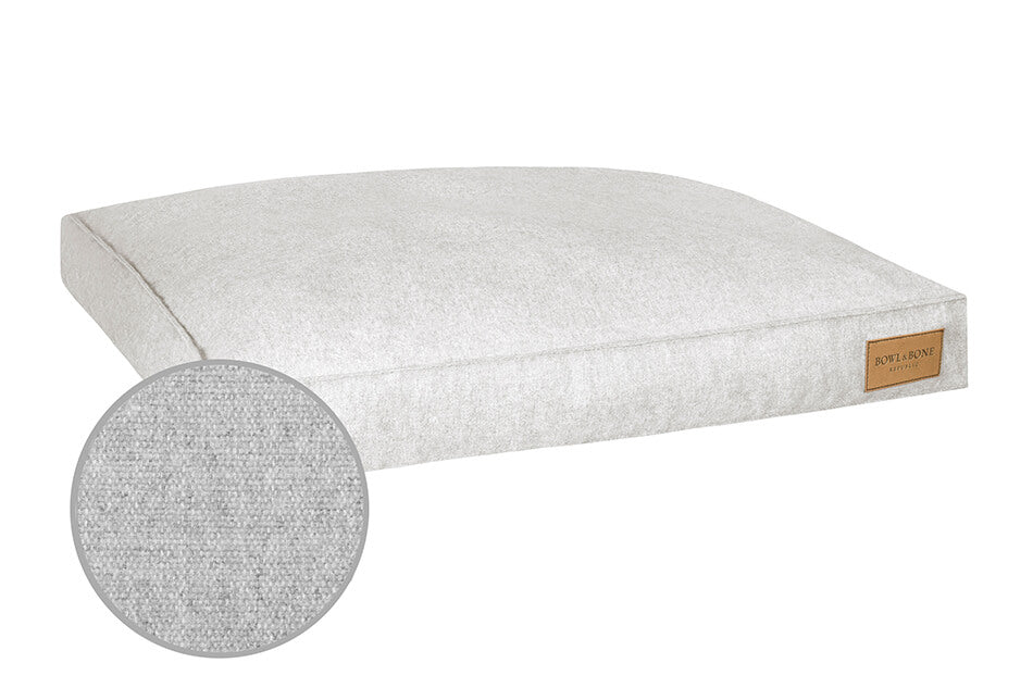 A Bowl&Bone Republic dog cushion bed LOFT grey in a light grey color.