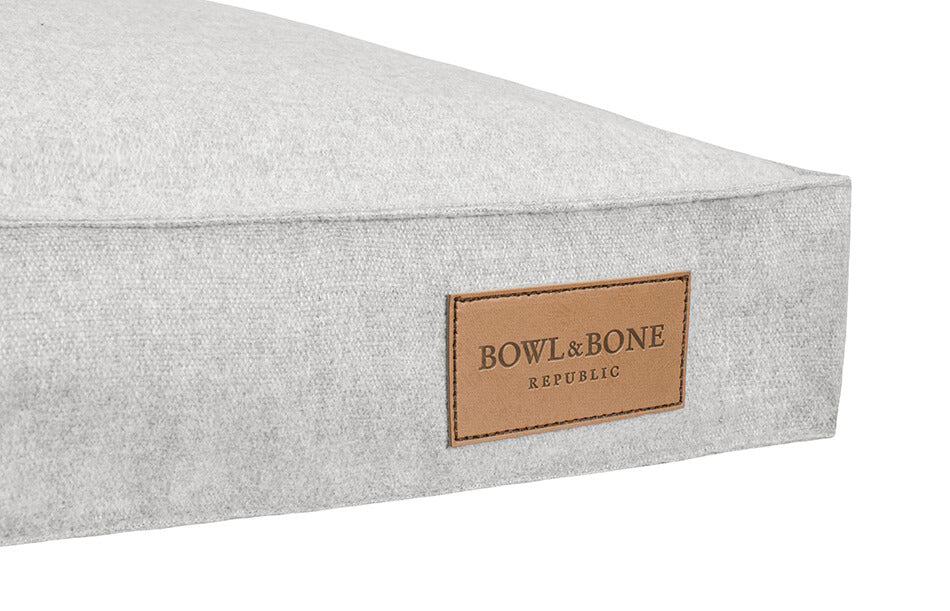 A dog cushion bed with a leather label by Bolw&Bone Republic.