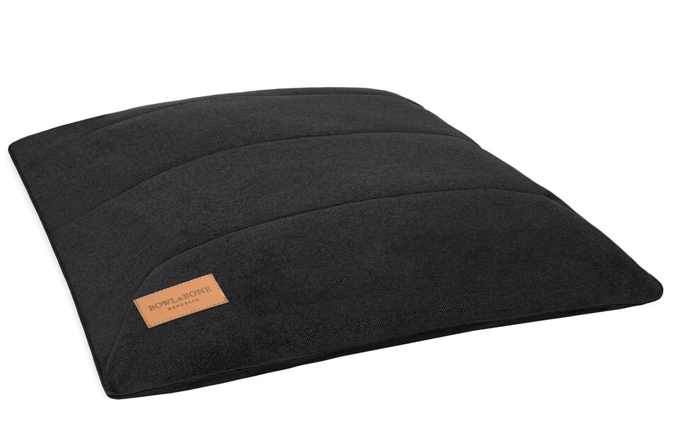 A Bowlandbone Republic black dog cushion bed URBAN graphite with a brown label on it.