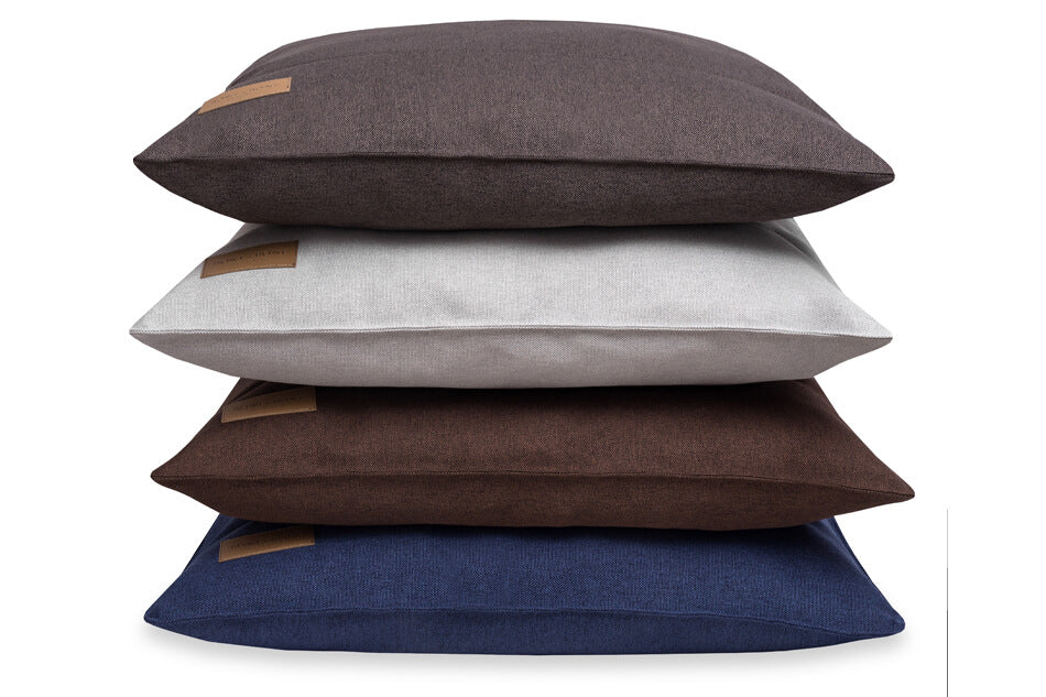 Four dog cushion beds stacked on top of each other by Bowlandbone.