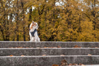 A Bowl&Bone Republic dog jacket sitting on a set of steps in a park.