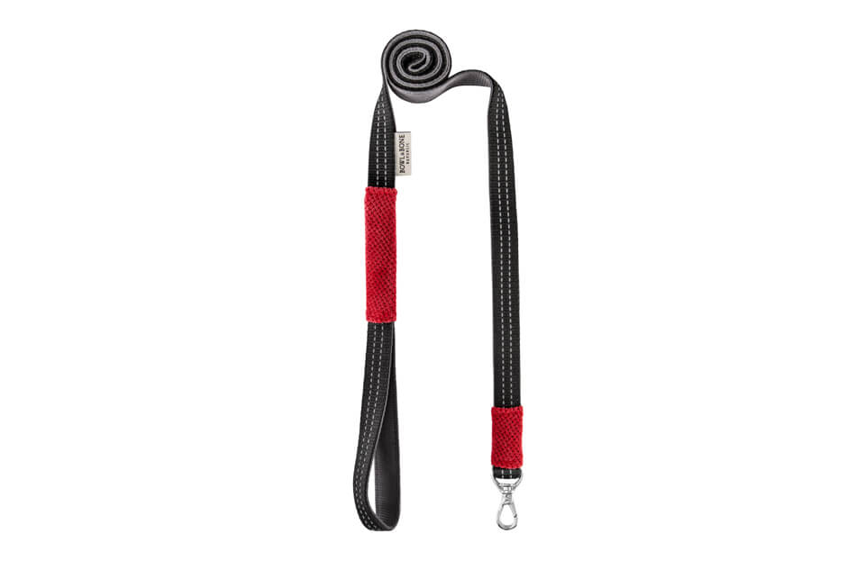 A Bowlandbone dog harness CANDY red with a black handle.
