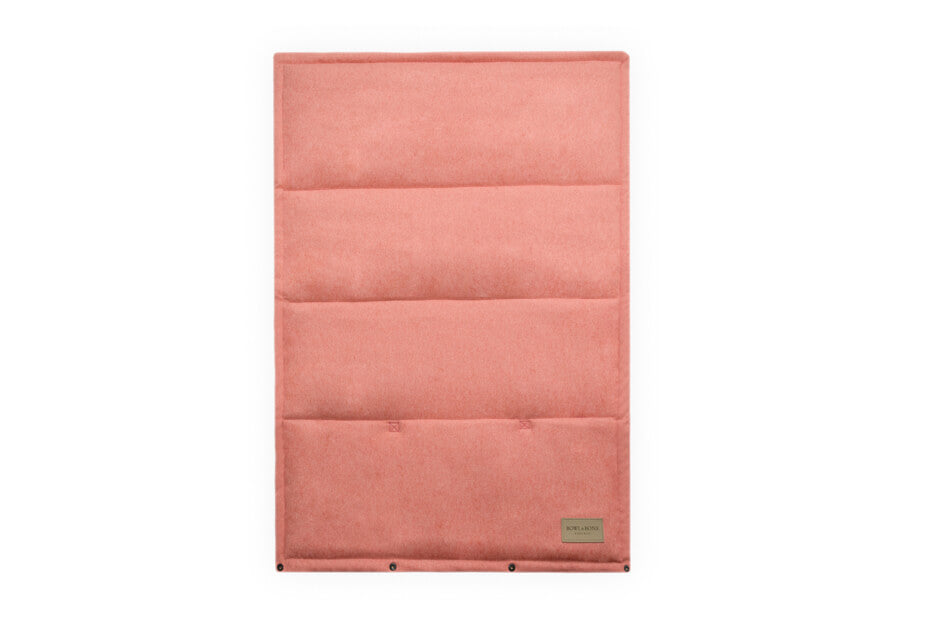 A Bowlandbone Republic dog mat LOFT coral with a small pocket on it.
