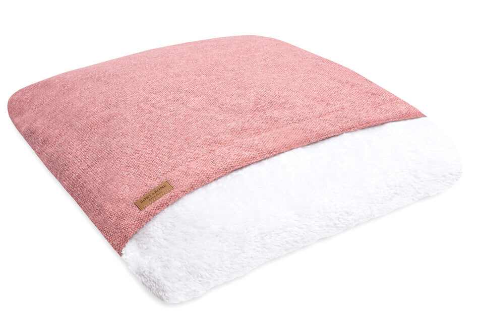 A pink dog sleeping bag by Bowlandbone on a white background, from Bowl&Bone Republic.