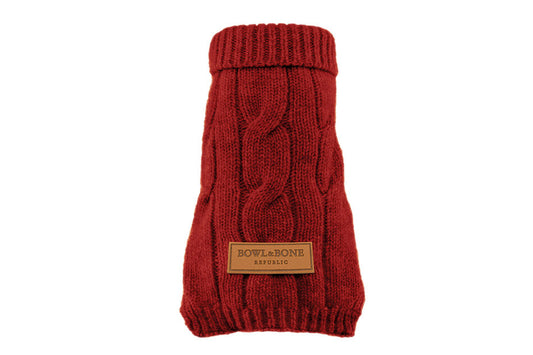 A dog sweater ASPEN red with a brown label on it, made by Bowl&Bone Republic.