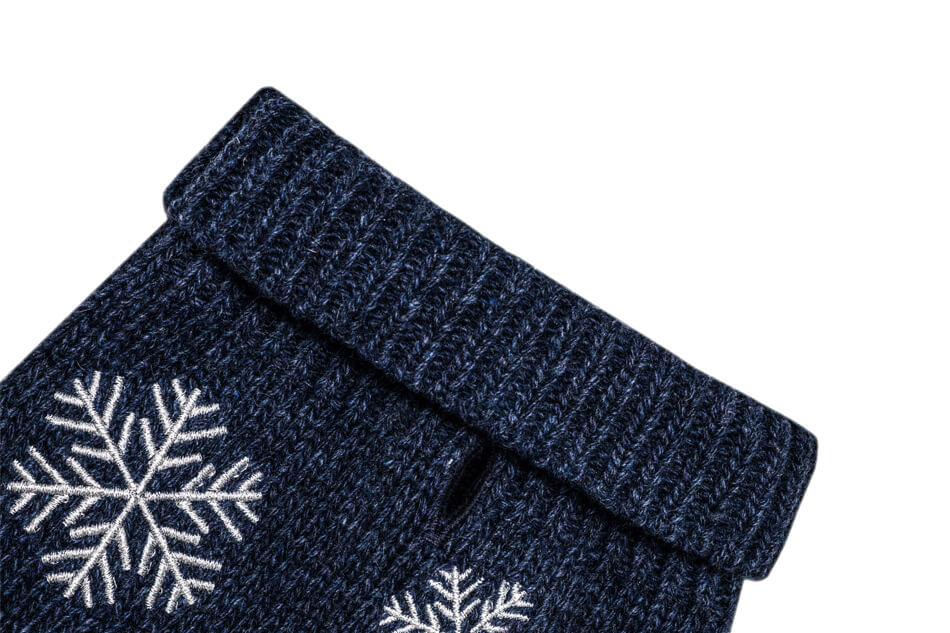 A pair of Bowl&Bone Republic blue socks with snowflakes on them.