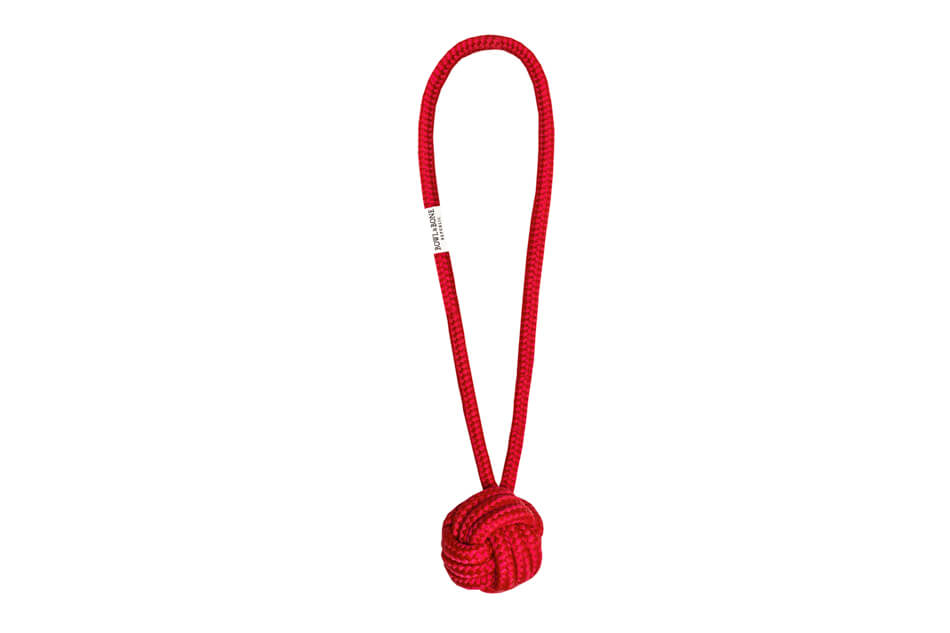 A dog toy with a red rope knot on a white background from Bowlandbone, an amazing online store for pet accessories.