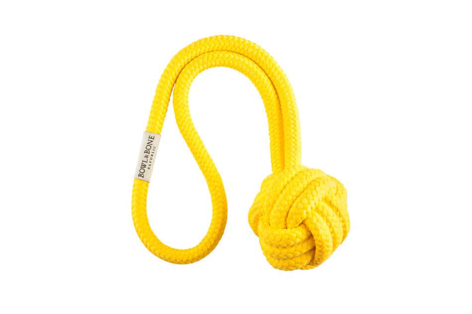A dog toy with a yellow rope knot on a white background from Bowl&Bone Republic.