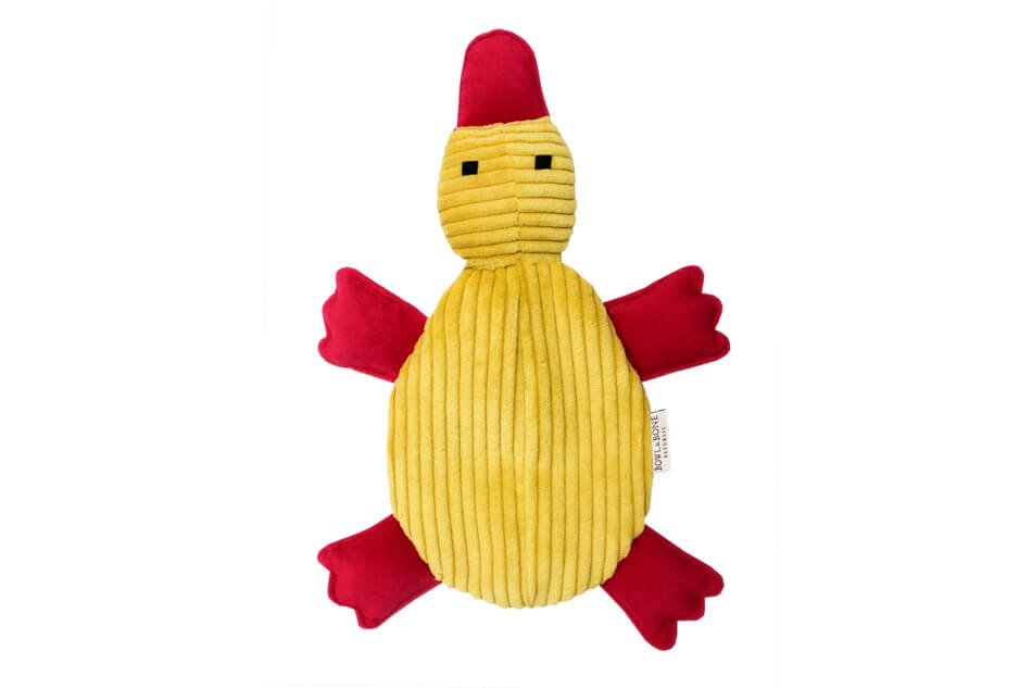 A yellow and red stuffed dog toy DUCKIE on a white background from the brand Bowlandbone Republic.