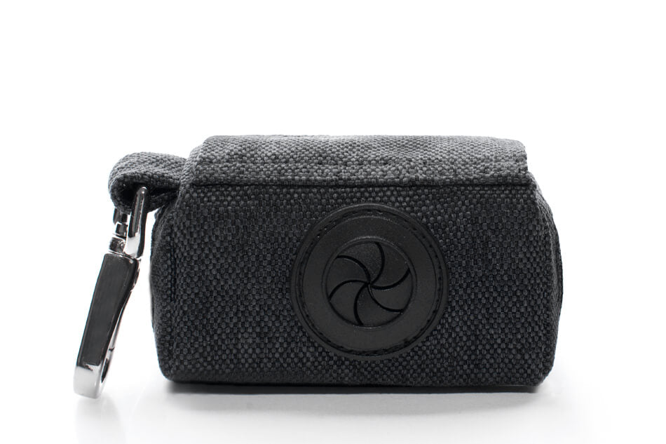 A Bowlandbone Republic dog waste bag holder MINI in black with a key ring attached to it.