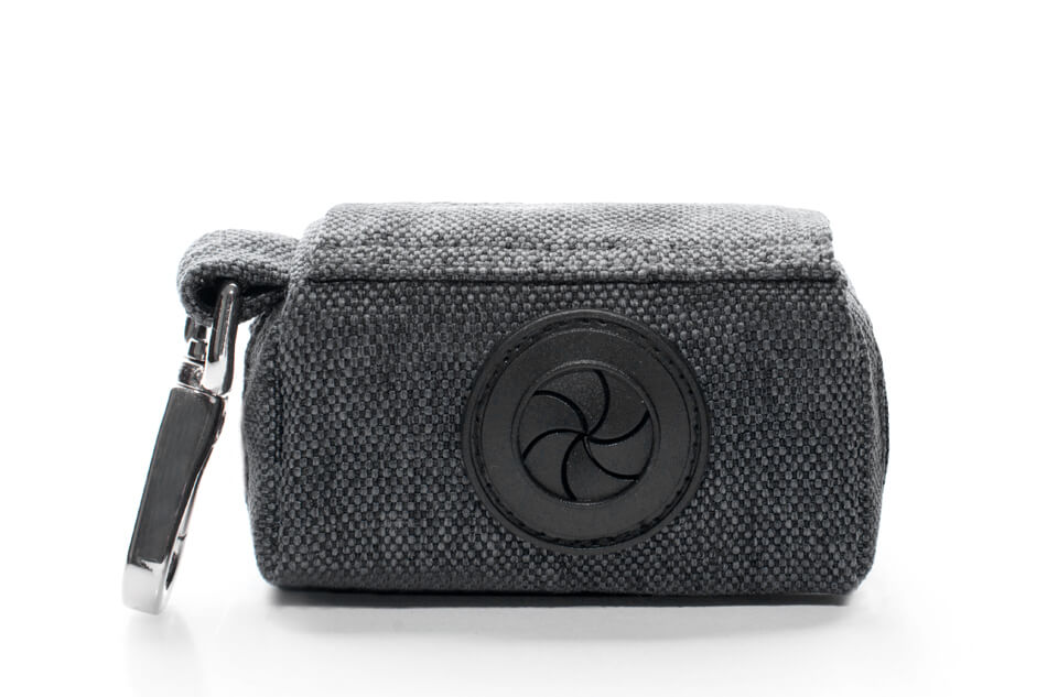A Bowlandbone dog waste bag holder MINI graphite with a key ring attached to it.