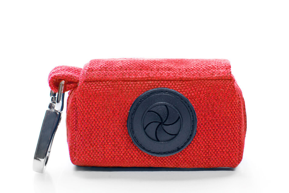 A Bowl&Bone Republic dog waste bag holder with a blue button on it.