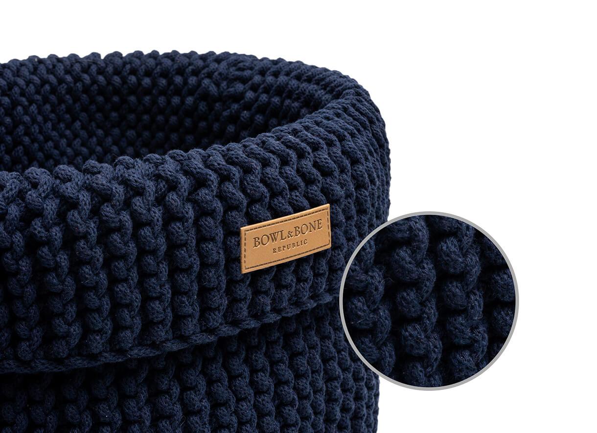 A Bowlandbone navy COTTON basket for dog toys with a label on it.